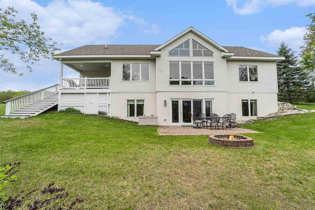 9030 Sugar Tree Ln, Charlevoix, MI 49720 - back of property with a fire pit, a yard, stairs, and a patio area