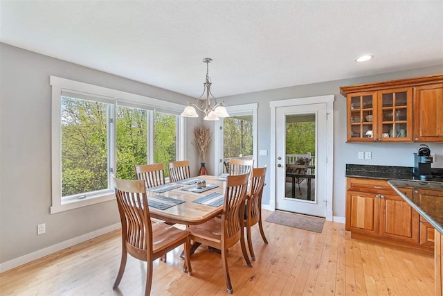 9030 Sugar Tree Ln, Charlevoix, MI 49720 - dining room with a chandelier, baseboards, light wood-style floors, and recessed lighting