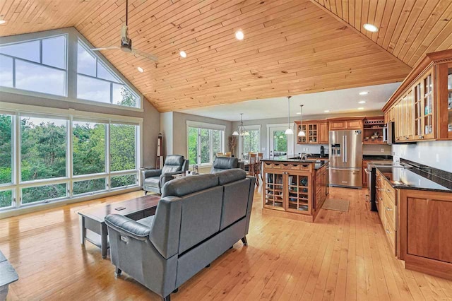 9030 Sugar Tree Ln, Charlevoix, MI 49720 - living room with wood ceiling, light wood finished floors, high vaulted ceiling, and recessed lighting