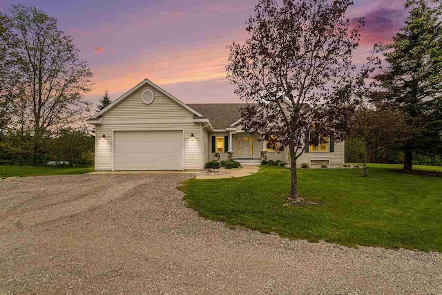 9030 Sugar Tree Ln, Charlevoix, MI 49720 - view of front facade featuring an attached garage, driveway, and a yard