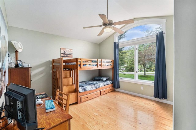 9030 Sugar Tree Ln, Charlevoix, MI 49720 - bedroom featuring wood finished floors, lofted ceiling, baseboards, and a ceiling fan
