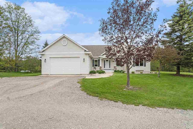 9030 Sugar Tree Ln, Charlevoix, MI 49720 - ranch-style house with an attached garage, gravel driveway, and a front lawn