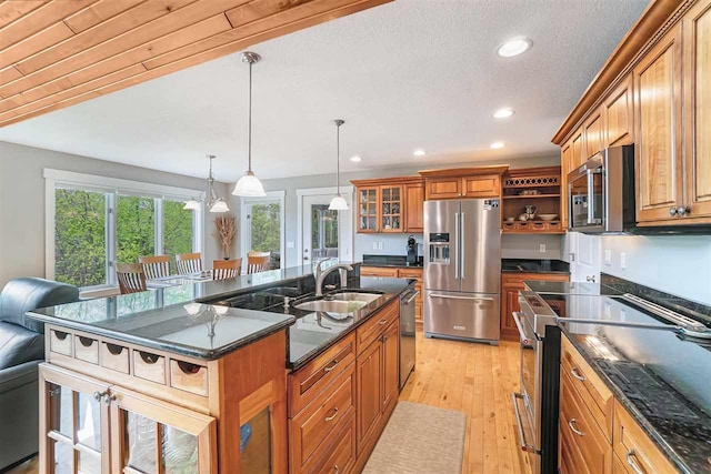 9030 Sugar Tree Ln, Charlevoix, MI 49720 - kitchen featuring stainless steel appliances, open shelves, a sink, brown cabinets, and recessed lighting