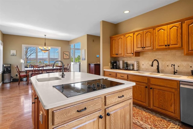 8530 Dustin Ln, East Jordan, MI 49727 - kitchen with dishwasher, black electric stovetop, a sink, a kitchen island with sink, and recessed lighting