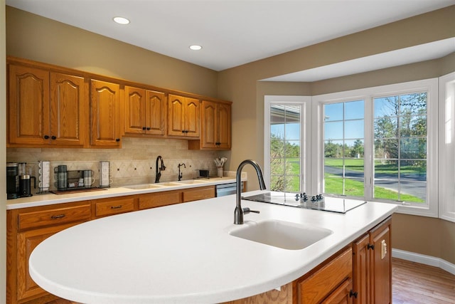 8530 Dustin Ln, East Jordan, MI 49727 - kitchen featuring a sink, decorative backsplash, light countertops, and recessed lighting