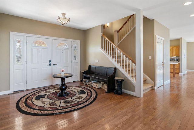8530 Dustin Ln, East Jordan, MI 49727 - entrance foyer with hardwood / wood-style floors, stairs, baseboards, and recessed lighting