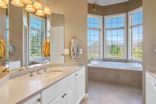 8530 Dustin Ln, East Jordan, MI 49727 - full bathroom with vanity, a garden tub, and tile patterned floors