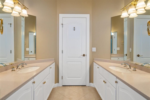 8530 Dustin Ln, East Jordan, MI 49727 - full bath featuring two vanities, tile patterned flooring, and baseboards
