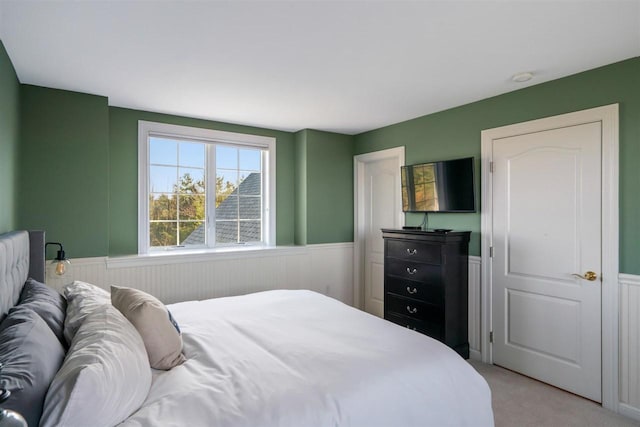 8530 Dustin Ln, East Jordan, MI 49727 - bedroom featuring wainscoting and light carpet
