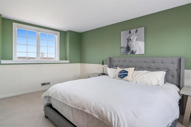 8530 Dustin Ln, East Jordan, MI 49727 - carpeted bedroom with a wainscoted wall