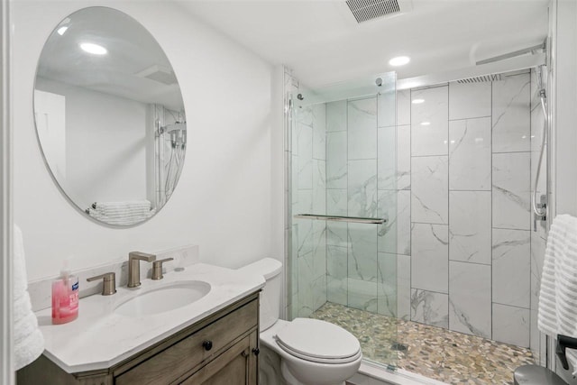 8530 Dustin Ln, East Jordan, MI 49727 - full bathroom featuring toilet, a stall shower, vanity, and recessed lighting