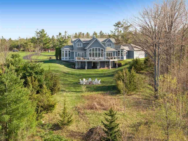 8530 Dustin Ln, East Jordan, MI 49727 - back of house featuring a yard and a deck