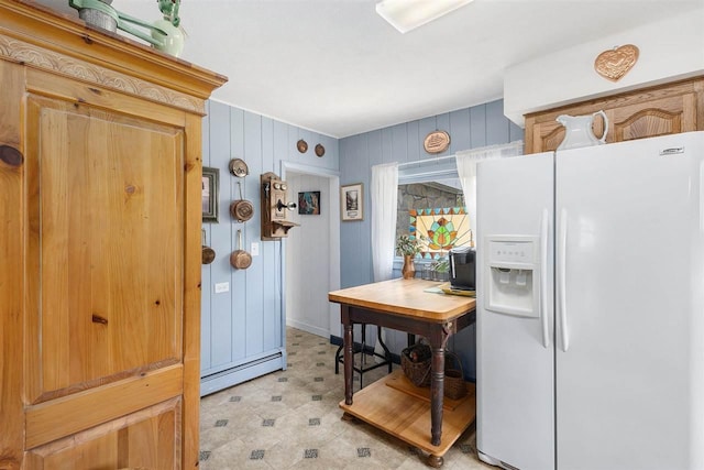 6073 Rocky Beach Ave, Charlevoix, MI 49720 - kitchen with white fridge with ice dispenser, a baseboard radiator, light flooring, an office area, and wood walls