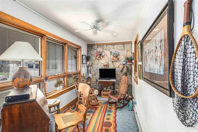 6073 Rocky Beach Ave, Charlevoix, MI 49720 - living area featuring a ceiling fan, a baseboard radiator, baseboards, crown molding, and carpet flooring