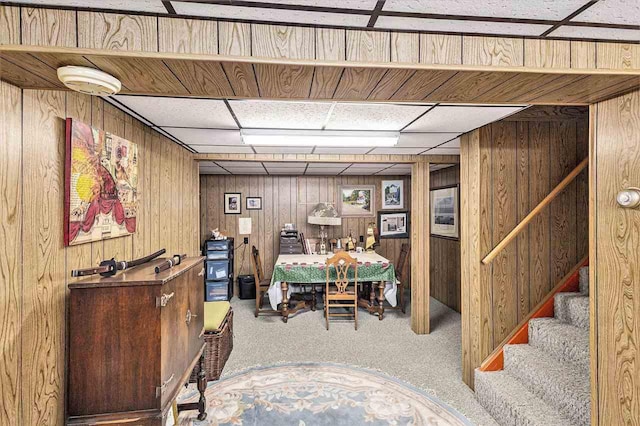 6073 Rocky Beach Ave, Charlevoix, MI 49720 - finished basement with carpet floors, wooden walls, a paneled ceiling, and stairs