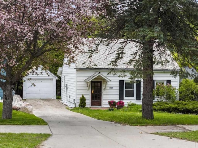 1117 E Mitchell St, Petoskey, MI 49770 - view of front of home with driveway and an outbuilding