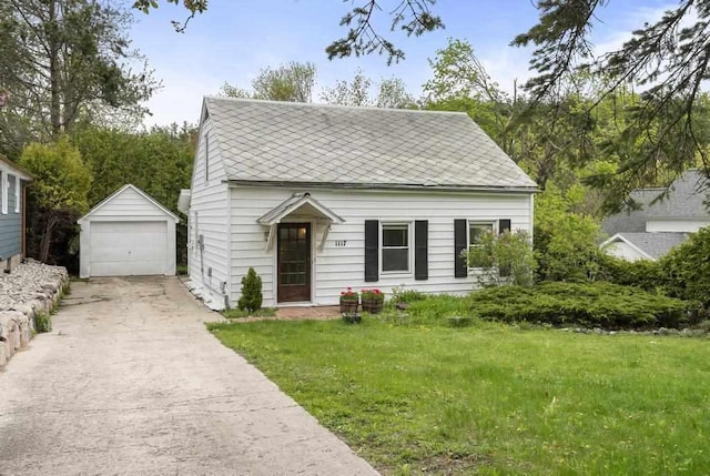 1117 E Mitchell St, Petoskey, MI 49770 - view of front of house with an outbuilding, a garage, driveway, and a shingled roof