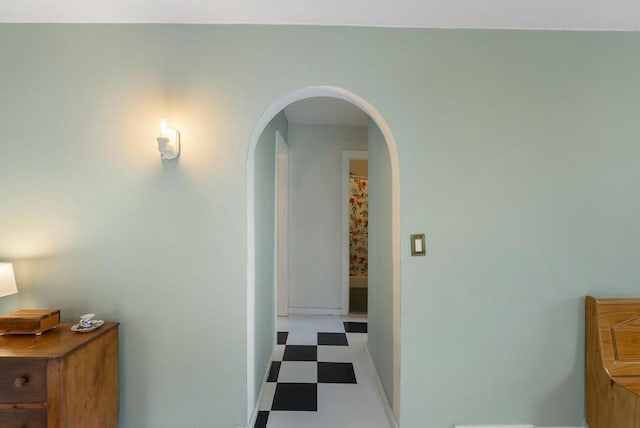 1117 E Mitchell St, Petoskey, MI 49770 - hallway with tile patterned floors, arched walkways, and baseboards