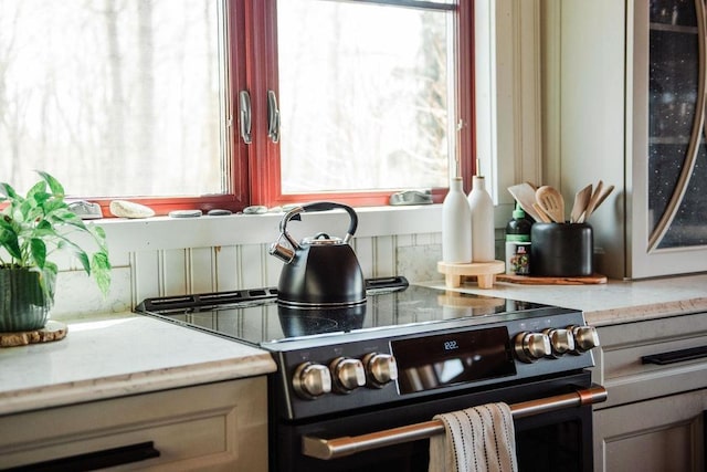 2149 Old Horton Bay Rd, Boyne City, MI 49712 - kitchen with stainless steel electric stove, healthy amount of natural light, and light countertops