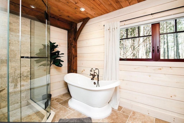 2149 Old Horton Bay Rd, Boyne City, MI 49712 - full bathroom with wood ceiling, stone tile floors, a stall shower, a soaking tub, and wood walls