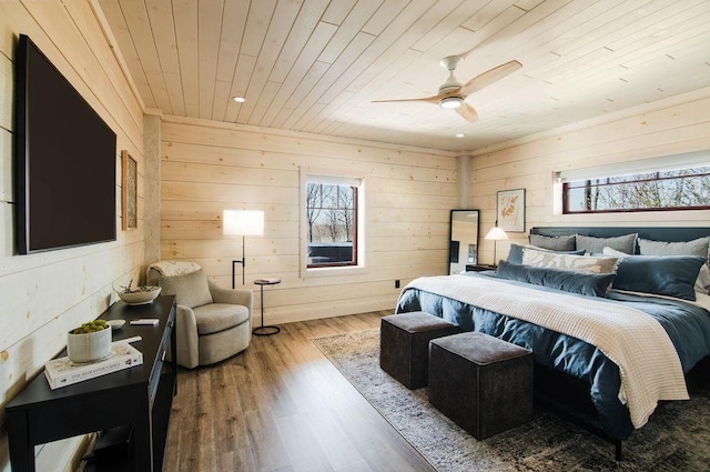 2149 Old Horton Bay Rd, Boyne City, MI 49712 - bedroom featuring wood ceiling, wood finished floors, wooden walls, and ceiling fan