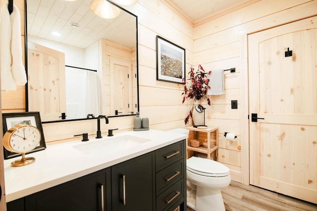 2149 Old Horton Bay Rd, Boyne City, MI 49712 - full bathroom with vanity, wood finished floors, toilet, and a shower with shower curtain