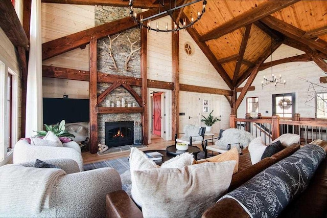 2149 Old Horton Bay Rd, Boyne City, MI 49712 - living area featuring a chandelier, high vaulted ceiling, wood finished floors, wood ceiling with exposed beams, and a fireplace