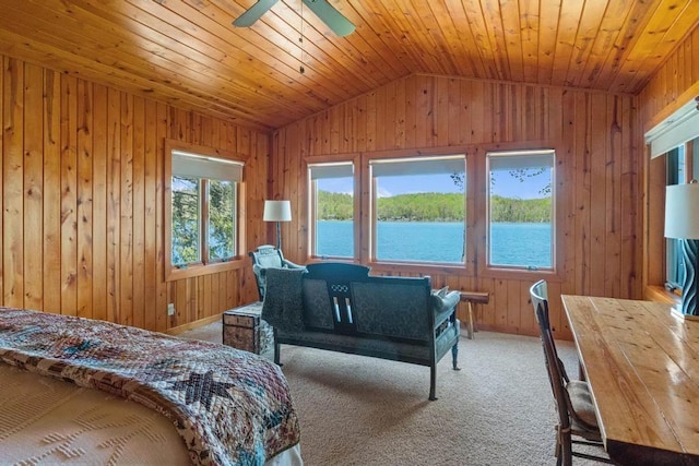 10819 Pioneer Trl, Boyne Falls, MI 49713 - carpeted bedroom with vaulted ceiling, wood walls, a water view, wood ceiling, and a ceiling fan