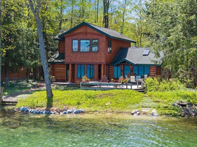 10819 Pioneer Trl, Boyne Falls, MI 49713 - back of property featuring a deck, log siding, and a shingled roof