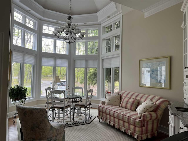2112 Golfview, Harbor Springs, MI 49740 - living room with ornamental molding, a chandelier, a towering ceiling, and wood finished floors