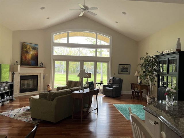 2112 Golfview, Harbor Springs, MI 49740 - living area with plenty of natural light, a glass covered fireplace, a ceiling fan, dark wood-style flooring, and high vaulted ceiling