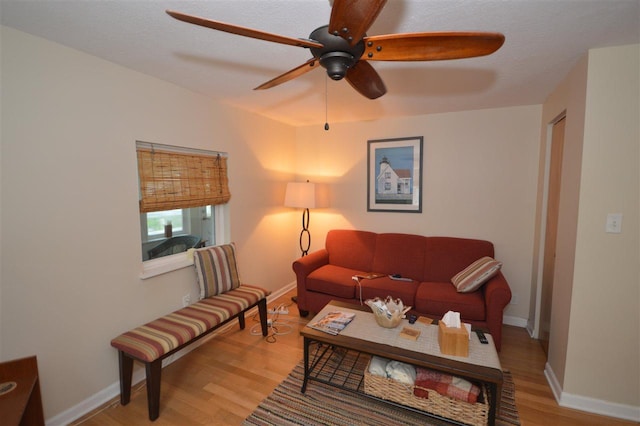 413 E Main St, Boyne City, MI 49712 - living room featuring light wood-style floors, a ceiling fan, and baseboards