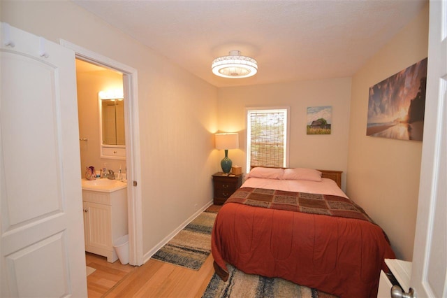 413 E Main St, Boyne City, MI 49712 - bedroom featuring light wood-style floors, bar area, and connected bathroom