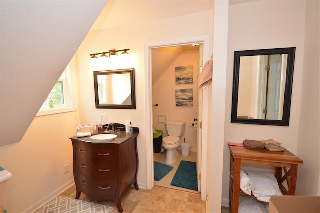 413 E Main St, Boyne City, MI 49712 - bathroom featuring toilet, vanity, and baseboards