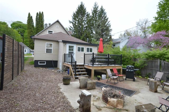 413 E Main St, Boyne City, MI 49712 - rear view of property featuring a deck and a patio area