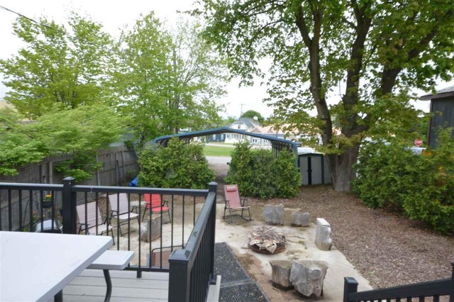 413 E Main St, Boyne City, MI 49712 - wooden deck featuring a fenced backyard and a patio area