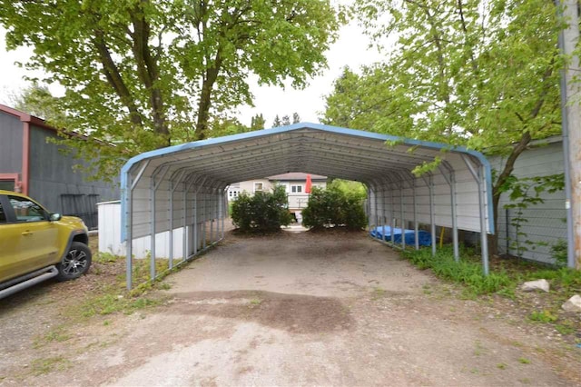 413 E Main St, Boyne City, MI 49712 - view of parking featuring a detached carport and driveway