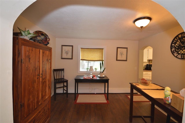 413 E Main St, Boyne City, MI 49712 - office area featuring arched walkways, dark wood-style floors, and baseboards