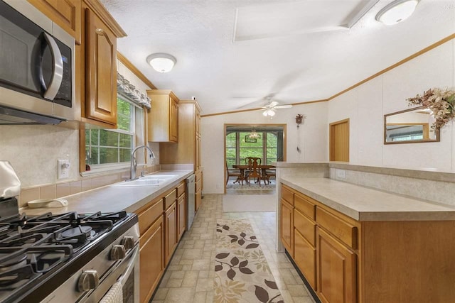 8370 Sisson, Bellaire, MI 49615 - kitchen featuring appliances with stainless steel finishes, ornamental molding, a sink, ceiling fan, and light countertops