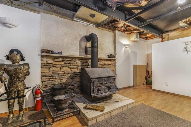 8370 Sisson, Bellaire, MI 49615 - living room with a wood stove, wood finished floors, and baseboards