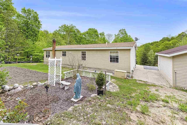 8370 Sisson, Bellaire, MI 49615 - rear view of house with a patio