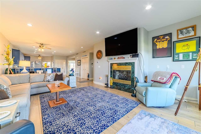 6040 Pine Lake Club Dr Unit 24, Charlevoix, MI 49720 - living area featuring a high end fireplace, a ceiling fan, recessed lighting, light wood-type flooring, and baseboards
