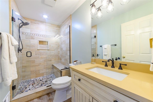 6040 Pine Lake Club Dr Unit 24, Charlevoix, MI 49720 - bathroom featuring a stall shower, toilet, vanity, and wood finished floors