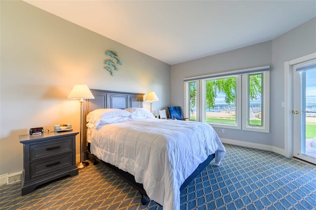 6040 Pine Lake Club Dr Unit 24, Charlevoix, MI 49720 - bedroom featuring dark colored carpet, baseboards, and access to outside