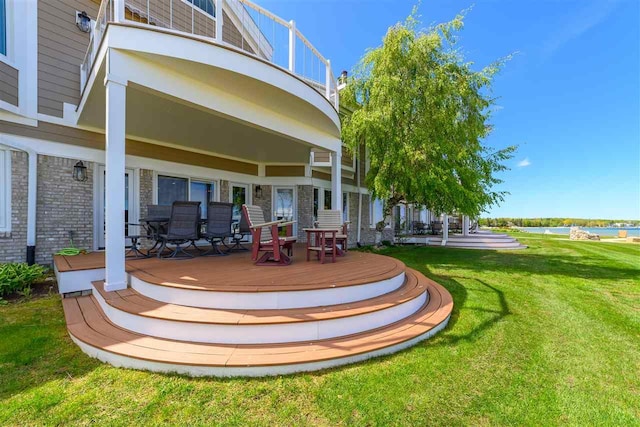 6040 Pine Lake Club Dr Unit 24, Charlevoix, MI 49720 - rear view of property with a balcony, a lawn, brick siding, and a deck with water view