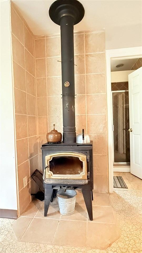 8902 Pickerel Lake Rd, Vanderbilt, MI 49795 - detailed view of a wood stove and tile walls