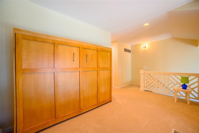 301 Michigan Ave Unit 13, Charlevoix, MI 49720 - hallway featuring light colored carpet, an upstairs landing, and baseboards