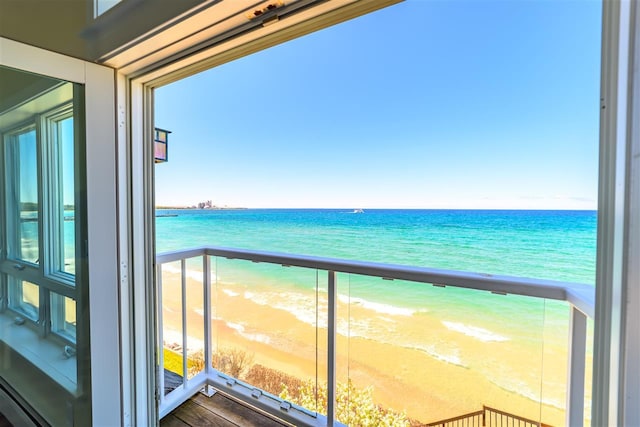 301 Michigan Ave Unit 13, Charlevoix, MI 49720 - balcony featuring view of water and beach