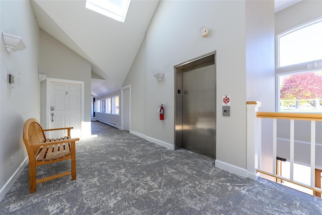 301 Michigan Ave Unit 13, Charlevoix, MI 49720 - carpeted entrance foyer with elevator, vaulted ceiling, a skylight, a baseboard heating unit, and baseboards