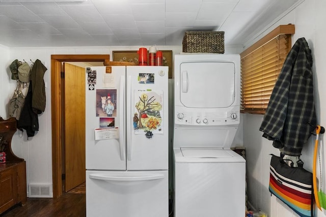680 N Lake Shore Dr, Harbor Springs, MI 49740 - laundry room featuring stacked washer / dryer and dark wood finished floors